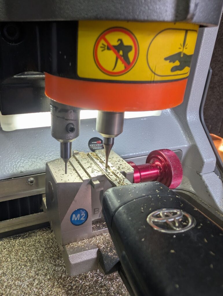 Key cutting machine cutting the blade of a Toyota remote key for a Toyota Aygo in Maidstone
